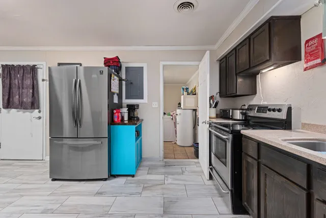 a kitchen with stainless steel appliances granite countertop a refrigerator and a stove