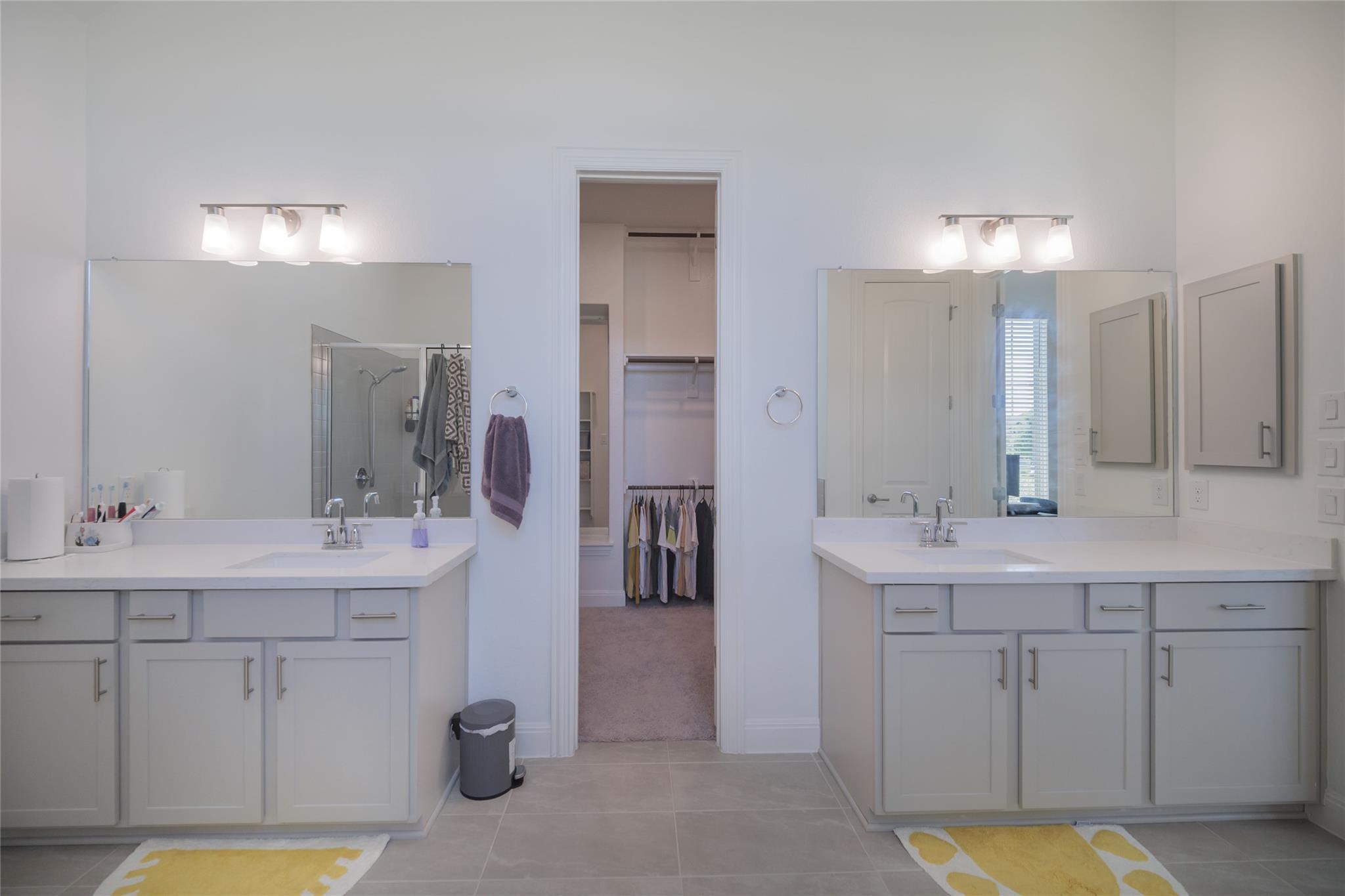 3049 Sage Ranch Drive Leander, TX 78641 - Photo 15 of 23 Twin vanities offer ample counter space and storage in this elegant bathroom.