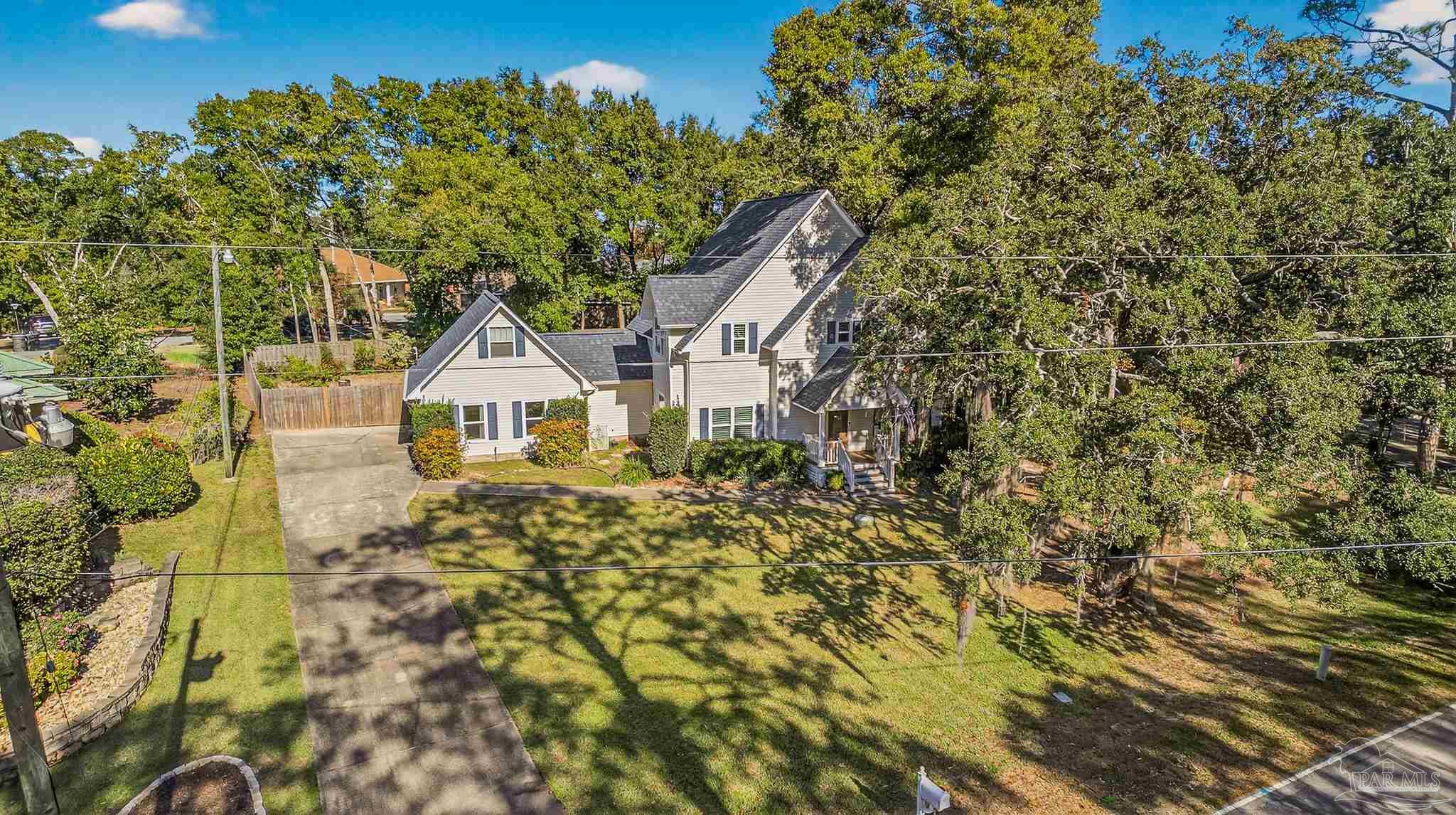 16360 Innerarity Point Road Pensacola, FL 32507 - Photo 1 of 56 a aerial view of a house with a yard and potted plants