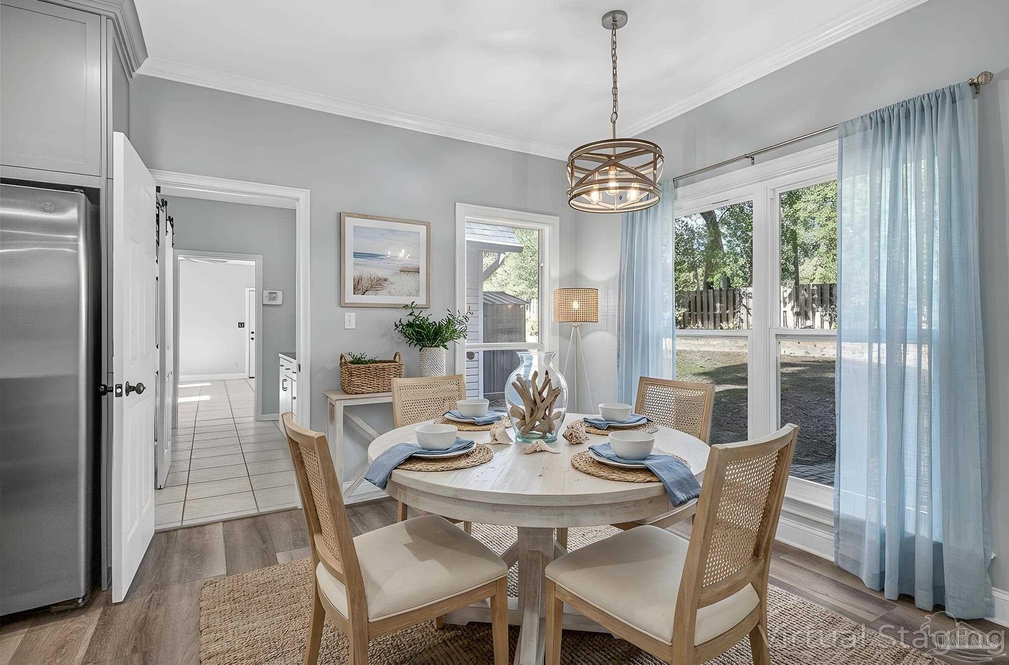 16360 Innerarity Point Road Pensacola, FL 32507 - Photo 17 of 56 a view of a dining room with furniture window and wooden floor