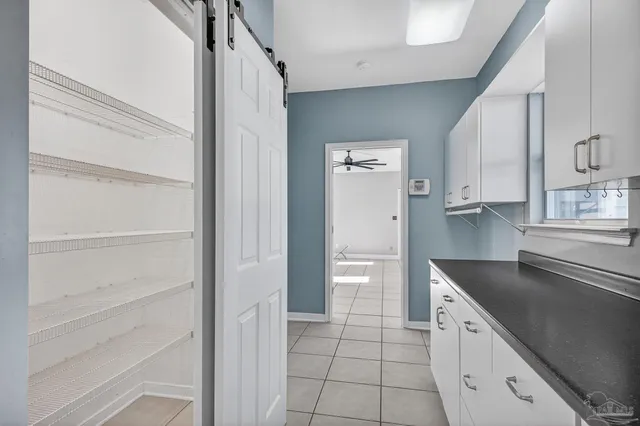 an empty room with closet and a ceiling fan