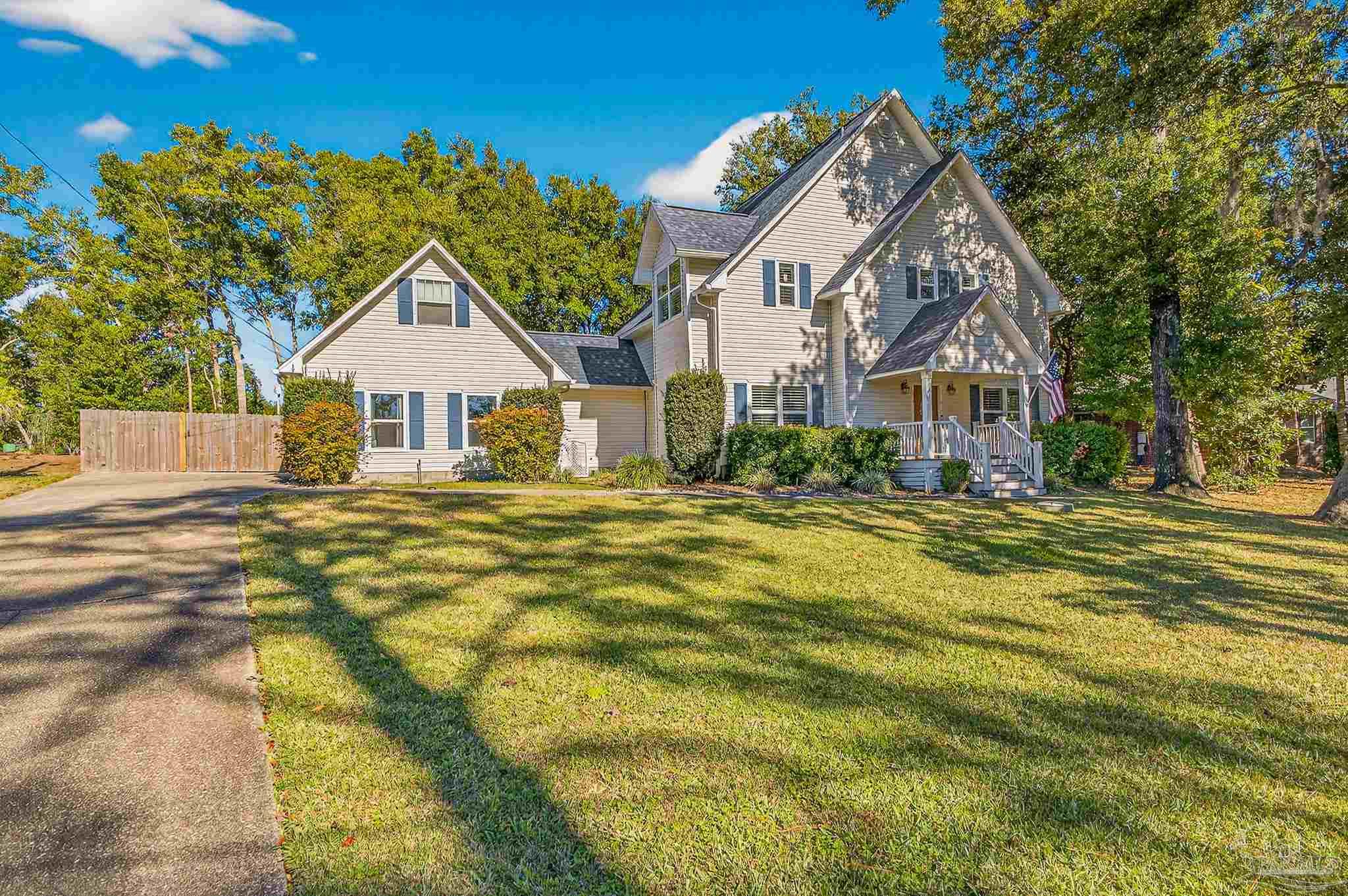 16360 Innerarity Point Road Pensacola, FL 32507 - Photo 2 of 56 a front view of a house with a yard
