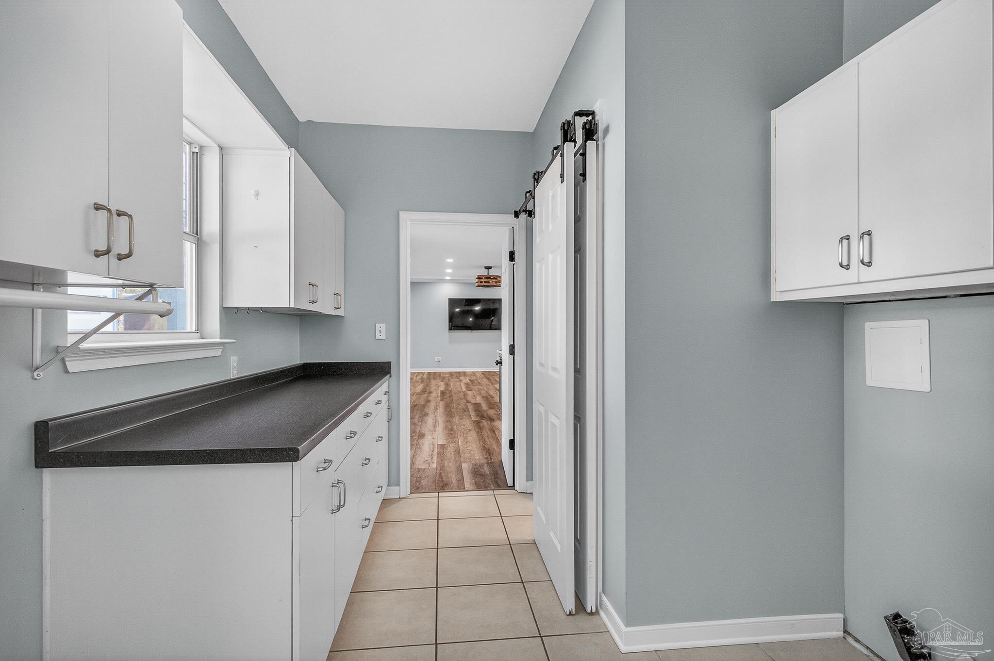 16360 Innerarity Point Road Pensacola, FL 32507 - Photo 21 of 56 a kitchen with granite countertop a refrigerator and a stove top oven