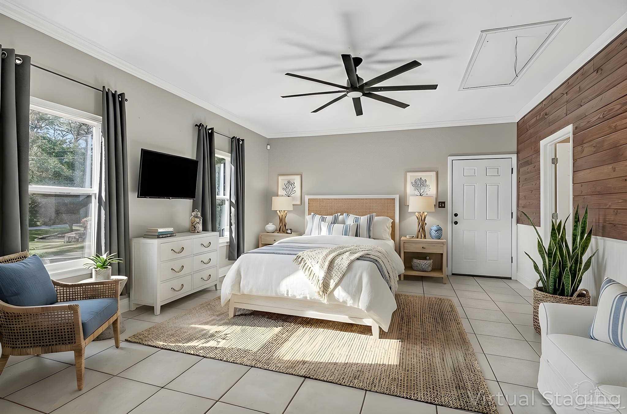 16360 Innerarity Point Road Pensacola, FL 32507 - Photo 25 of 56 a bed room with a bed a couch and a flat tv screen