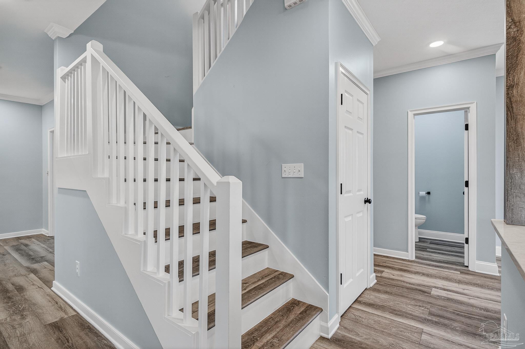 16360 Innerarity Point Road Pensacola, FL 32507 - Photo 28 of 56 a view of staircase with wooden floor and white walls