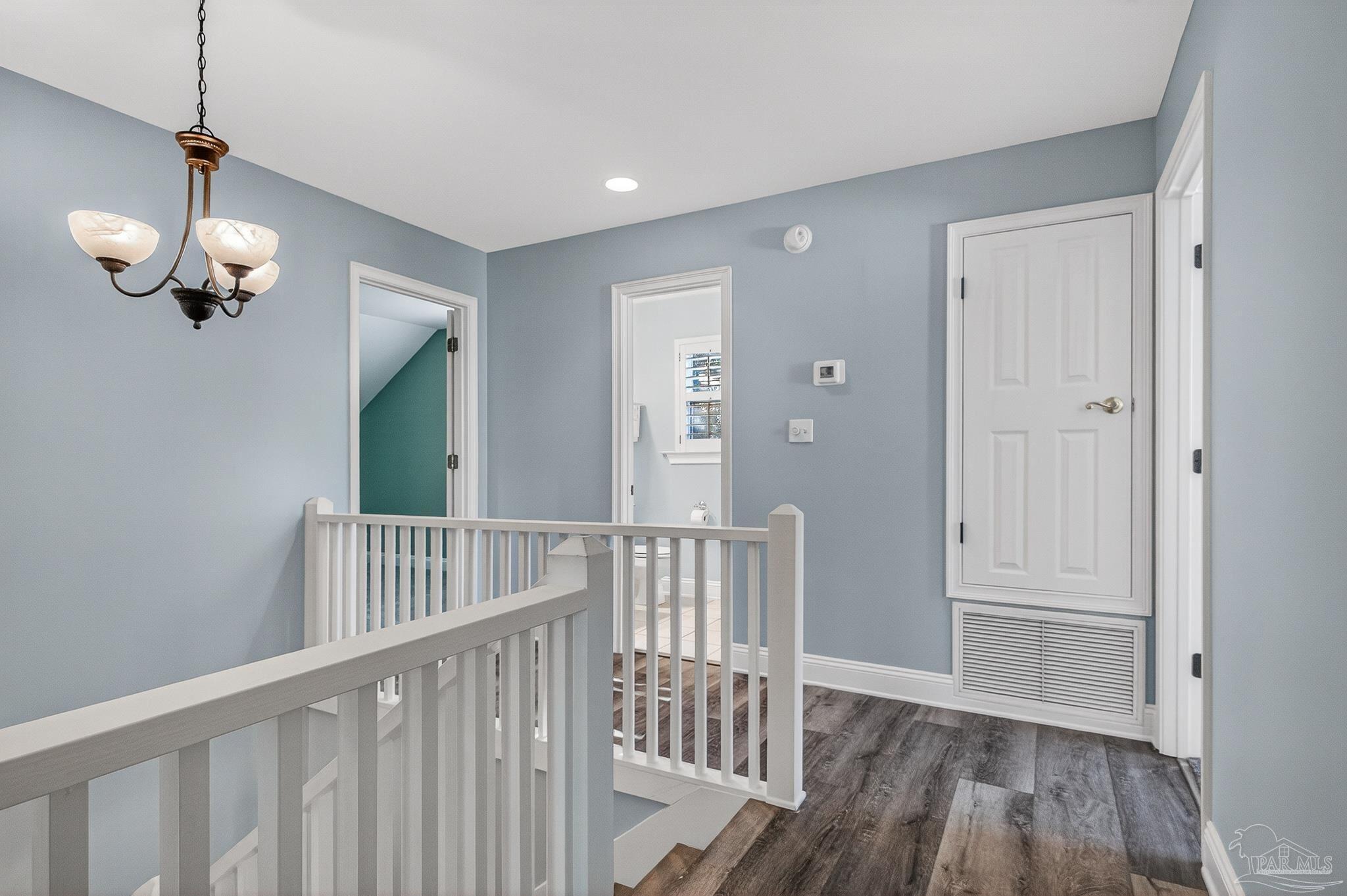 16360 Innerarity Point Road Pensacola, FL 32507 - Photo 29 of 56 a view of a hallway with wooden floor and stairs