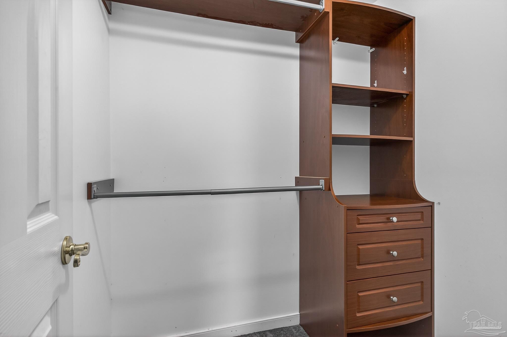 16360 Innerarity Point Road Pensacola, FL 32507 - Photo 32 of 56 a view of walk in closet with empty racks