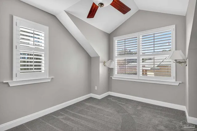 a view of a livingroom with a ceiling fan and window