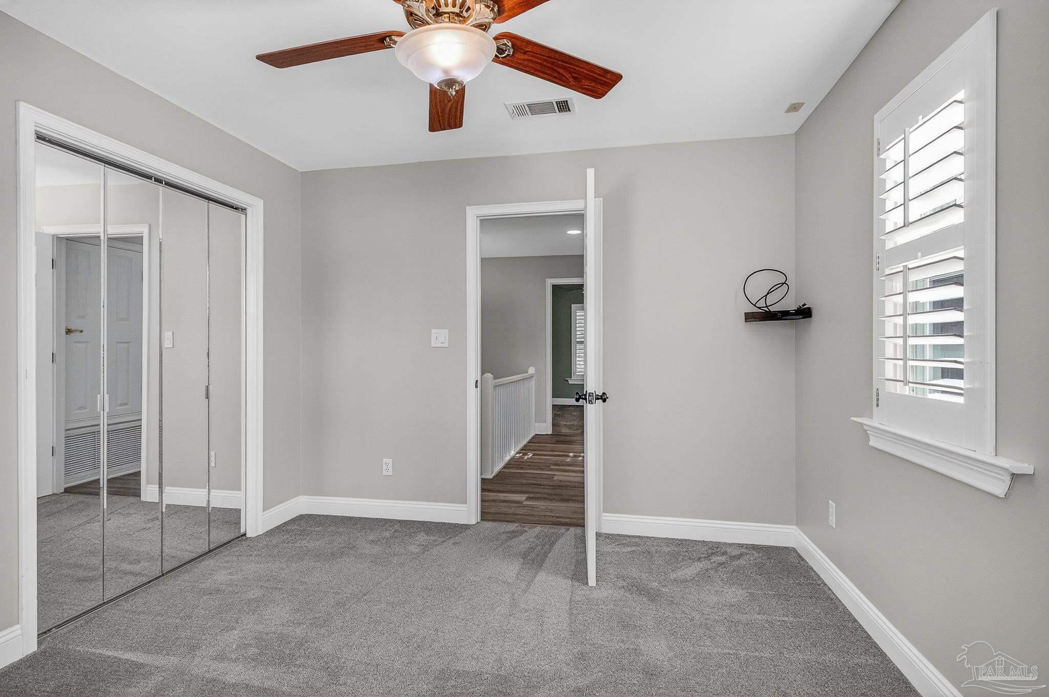 16360 Innerarity Point Road Pensacola, FL 32507 - Photo 39 of 56 wooden floor with window in an empty room