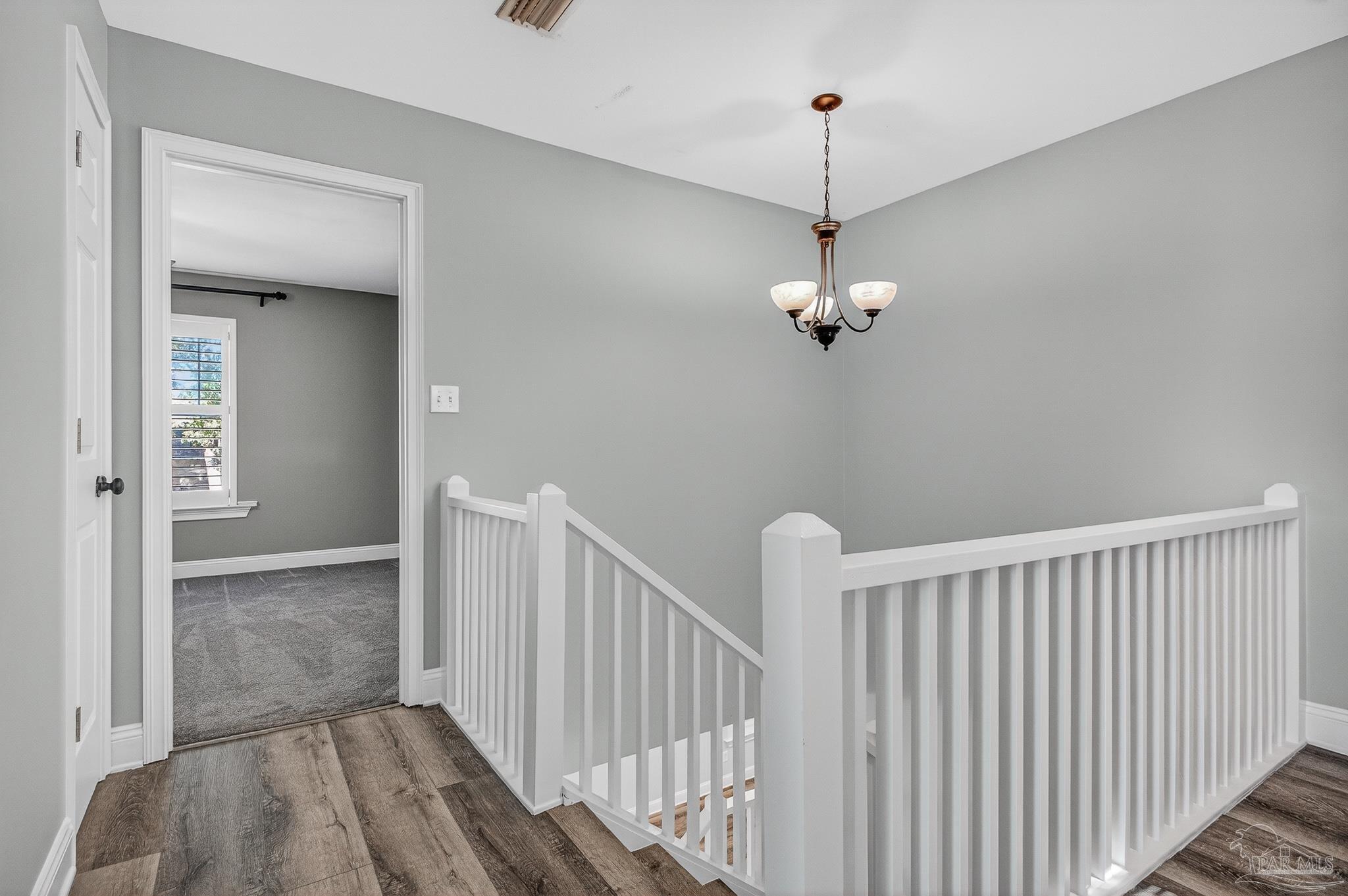 16360 Innerarity Point Road Pensacola, FL 32507 - Photo 40 of 56 a view of a hallway with a chandelier