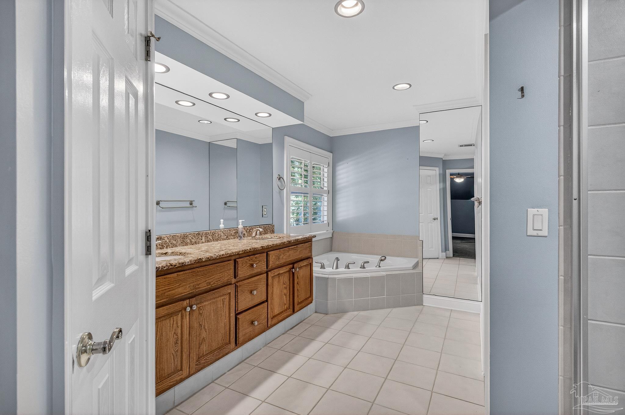 16360 Innerarity Point Road Pensacola, FL 32507 - Photo 44 of 56 a bathroom with a tub sink and mirror