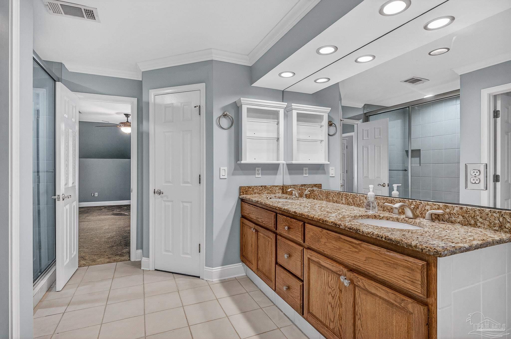 16360 Innerarity Point Road Pensacola, FL 32507 - Photo 47 of 56 a bathroom with a granite countertop sink a mirror and a shower