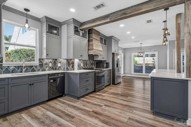 a kitchen with a refrigerator and a sink
