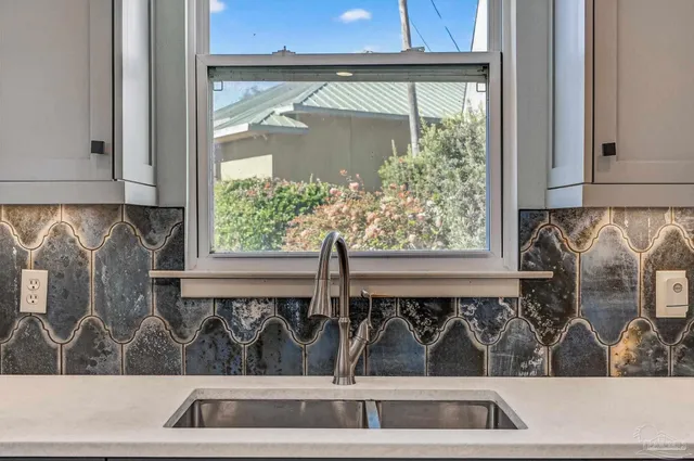 a kitchen with granite countertop a refrigerator and a stove top oven