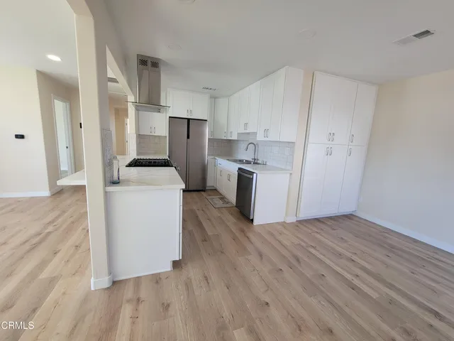 a view of kitchen with wooden floor