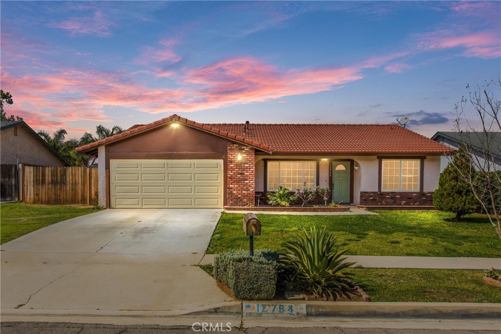 12794 Reed Avenue Grand Terrace, CA 92313 - Photo 1 of 1 a front view of a house with a yard and porch