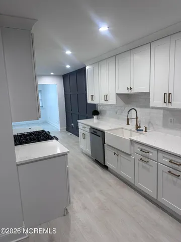 a kitchen with a sink stove and cabinets