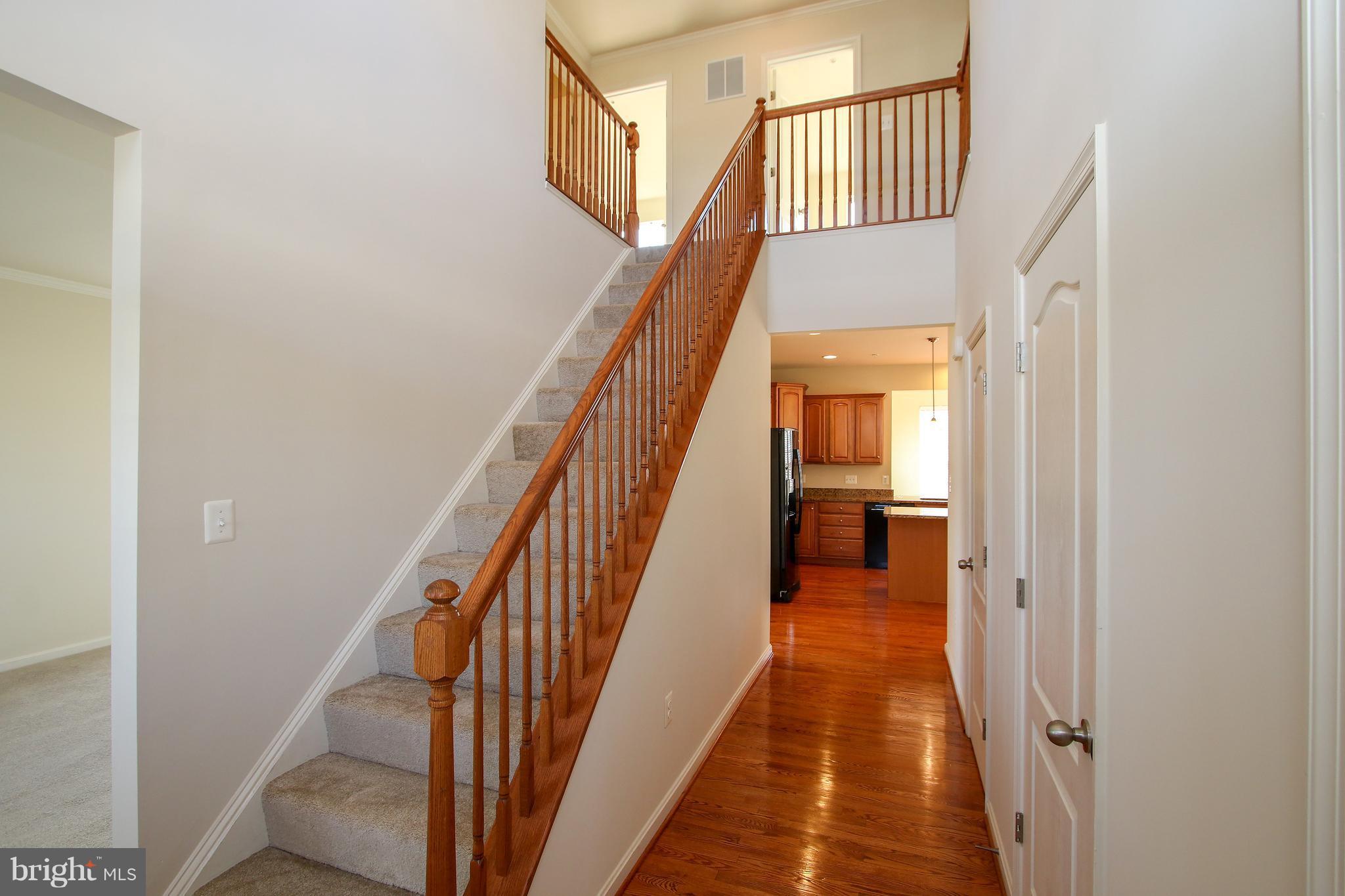 3905 Calico Circle Point of Rocks, MD 21777 - Photo 4 of 30 a view of a hallway with wooden floor and stairs