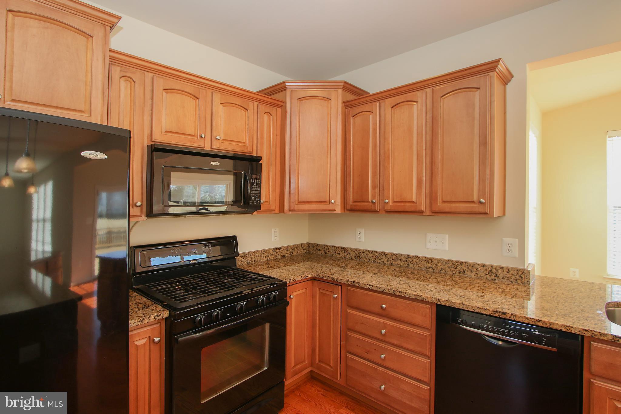 3905 Calico Circle Point of Rocks, MD 21777 - Photo 9 of 30 a kitchen with granite countertop a stove top oven microwave and cabinets