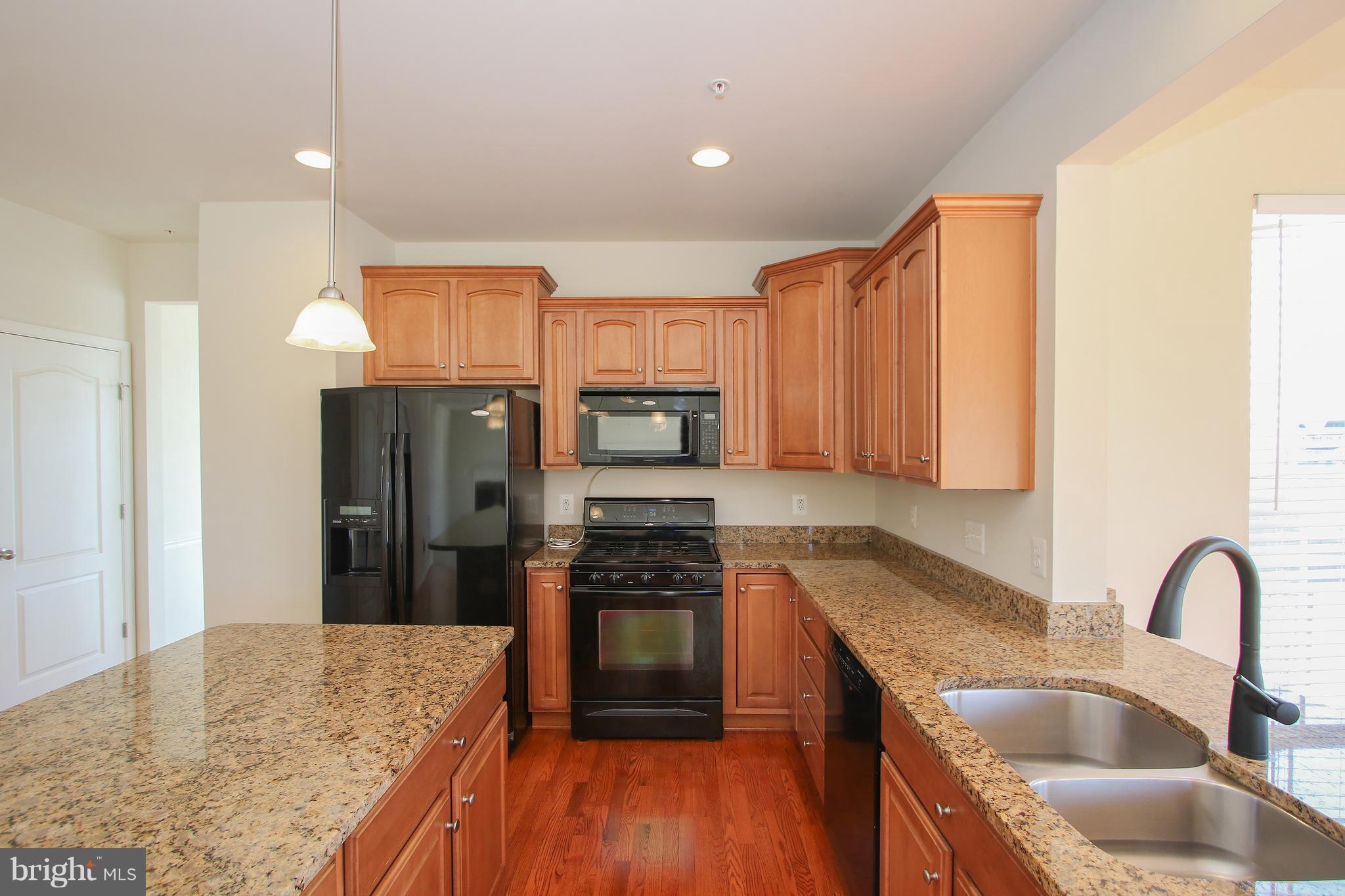 3905 Calico Circle Point of Rocks, MD 21777 - Photo 10 of 30 a kitchen with kitchen island granite countertop a stove sink and refrigerator
