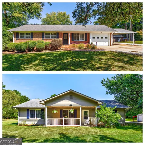 a view of a big yard in front of a brick house with large windows