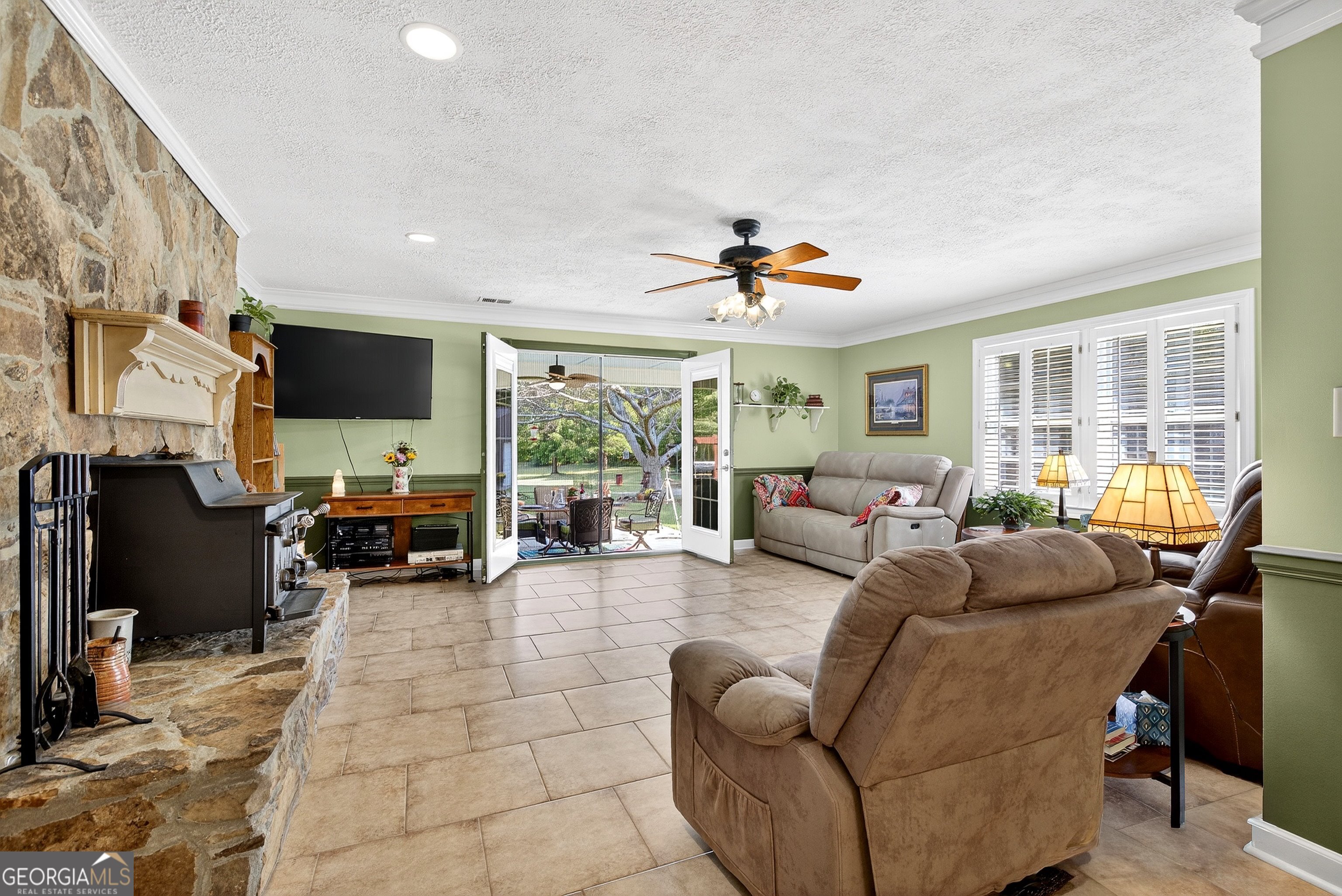 466 Minter Drive Hampton, GA 30228 - Photo 22 of 81 a living room with furniture and a flat screen tv