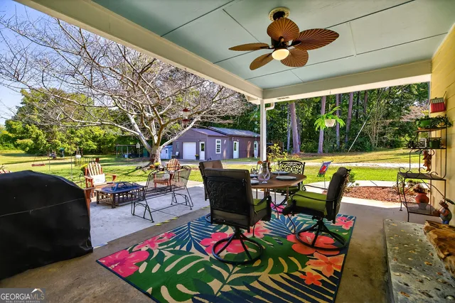 a view of an house with backyard space and seating area