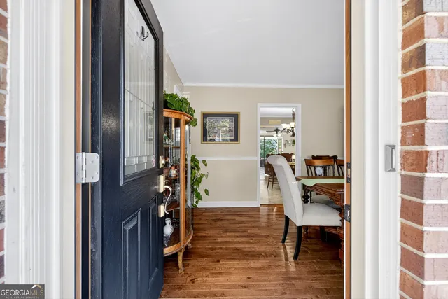a living room with furniture a table and a large window