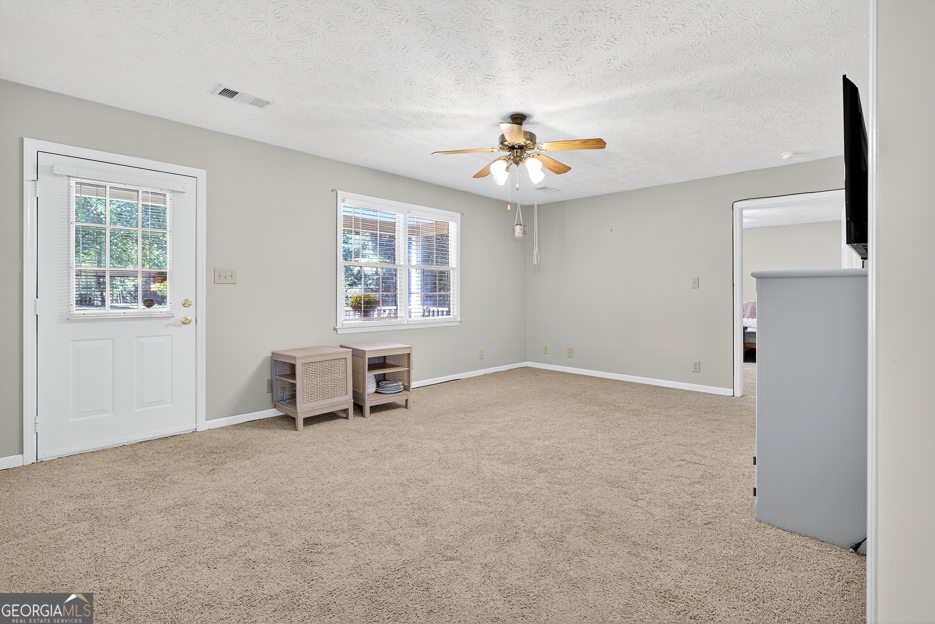 466 Minter Drive Hampton, GA 30228 - Photo 44 of 81 an empty room with windows and ceiling fan