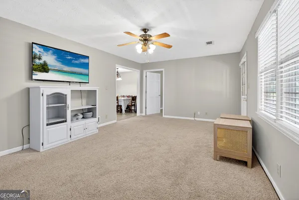a backyard of a house with a yard and outdoor seating
