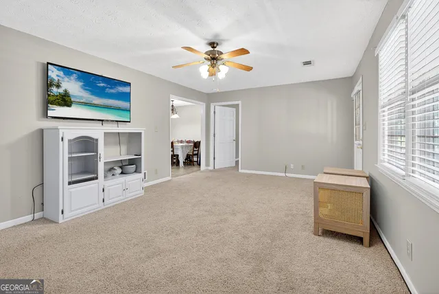 a backyard of a house with a yard and outdoor seating