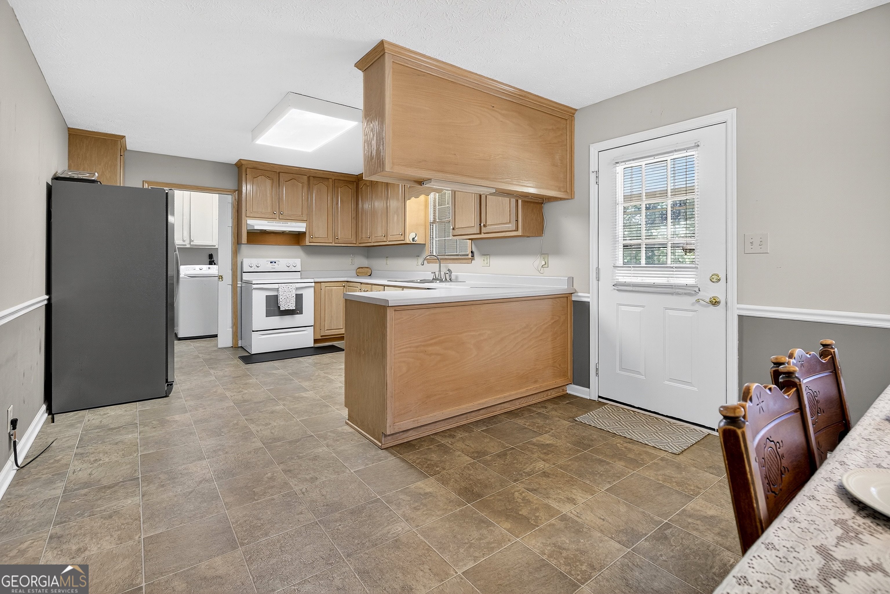 466 Minter Drive Hampton, GA 30228 - Photo 47 of 81 a kitchen with stainless steel appliances granite countertop a refrigerator sink stove and cabinets