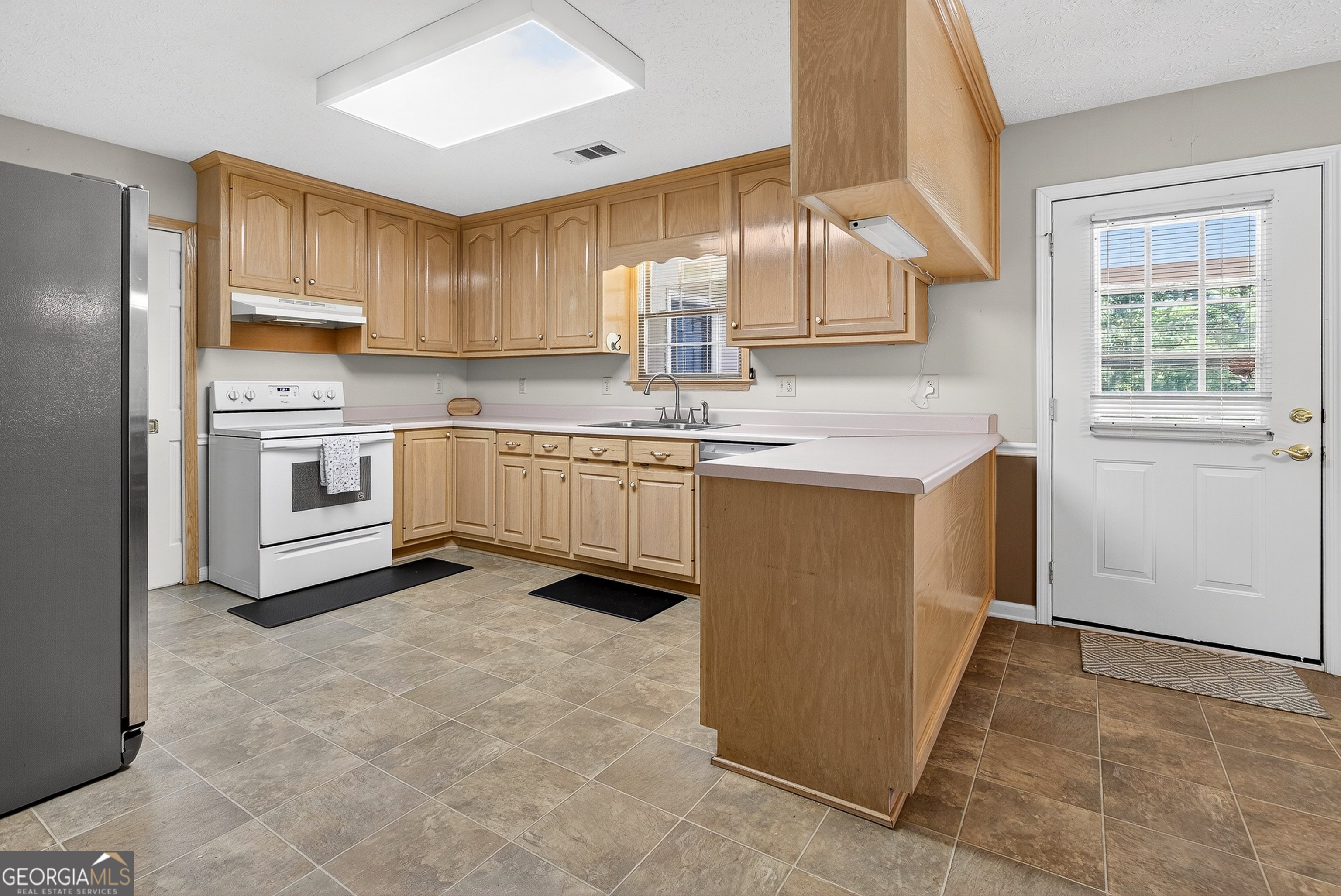 466 Minter Drive Hampton, GA 30228 - Photo 48 of 81 a kitchen with stainless steel appliances granite countertop a stove a sink and a refrigerator