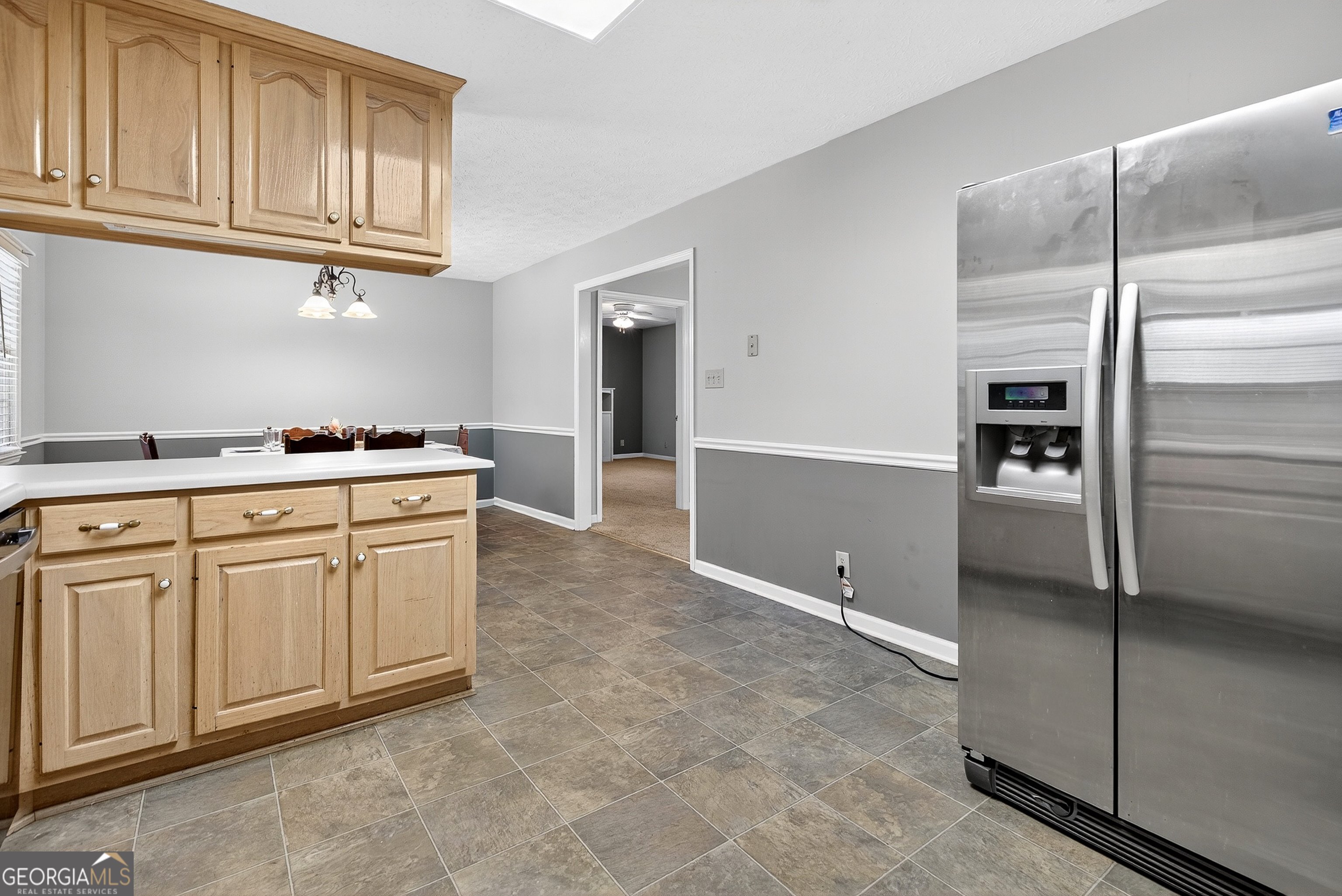 466 Minter Drive Hampton, GA 30228 - Photo 49 of 81 a kitchen with cabinets and a refrigerator