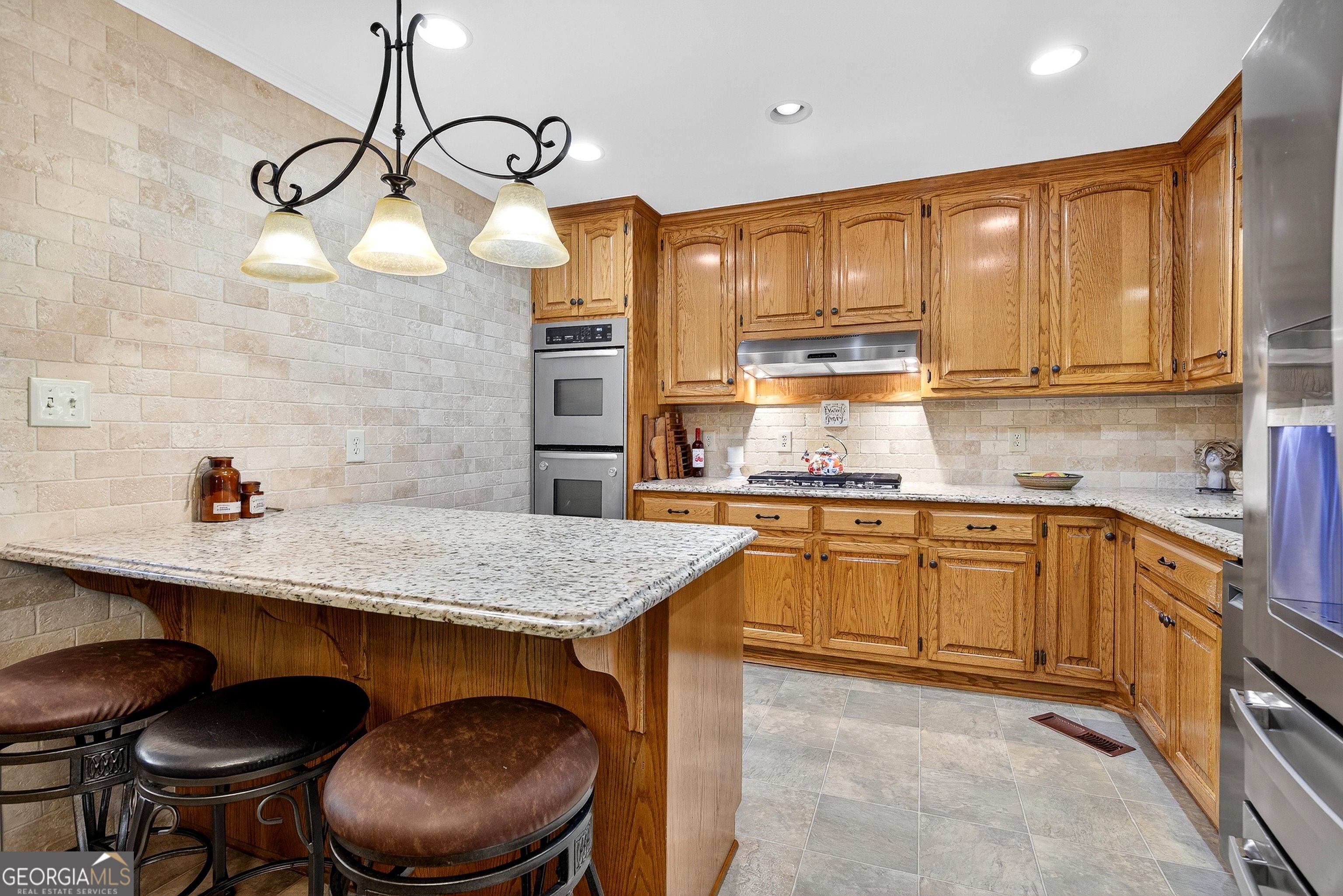 466 Minter Drive Hampton, GA 30228 - Photo 7 of 81 a kitchen with stainless steel appliances granite countertop a sink a stove a refrigerator cabinets and chairs