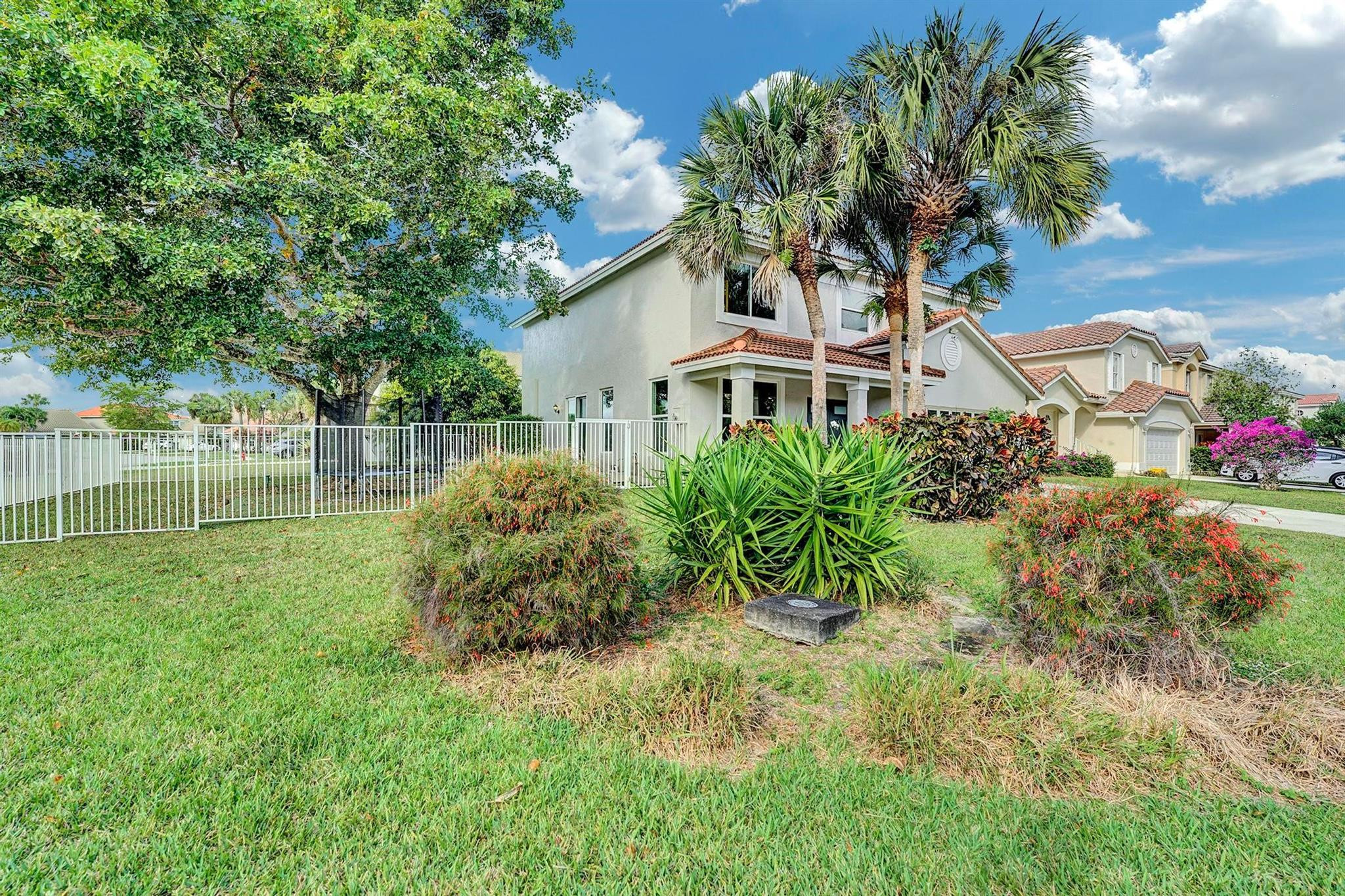 18219 Blue Lake Way Boca Raton, FL 33498 - Photo 31 of 39 a front view of a house with a garden