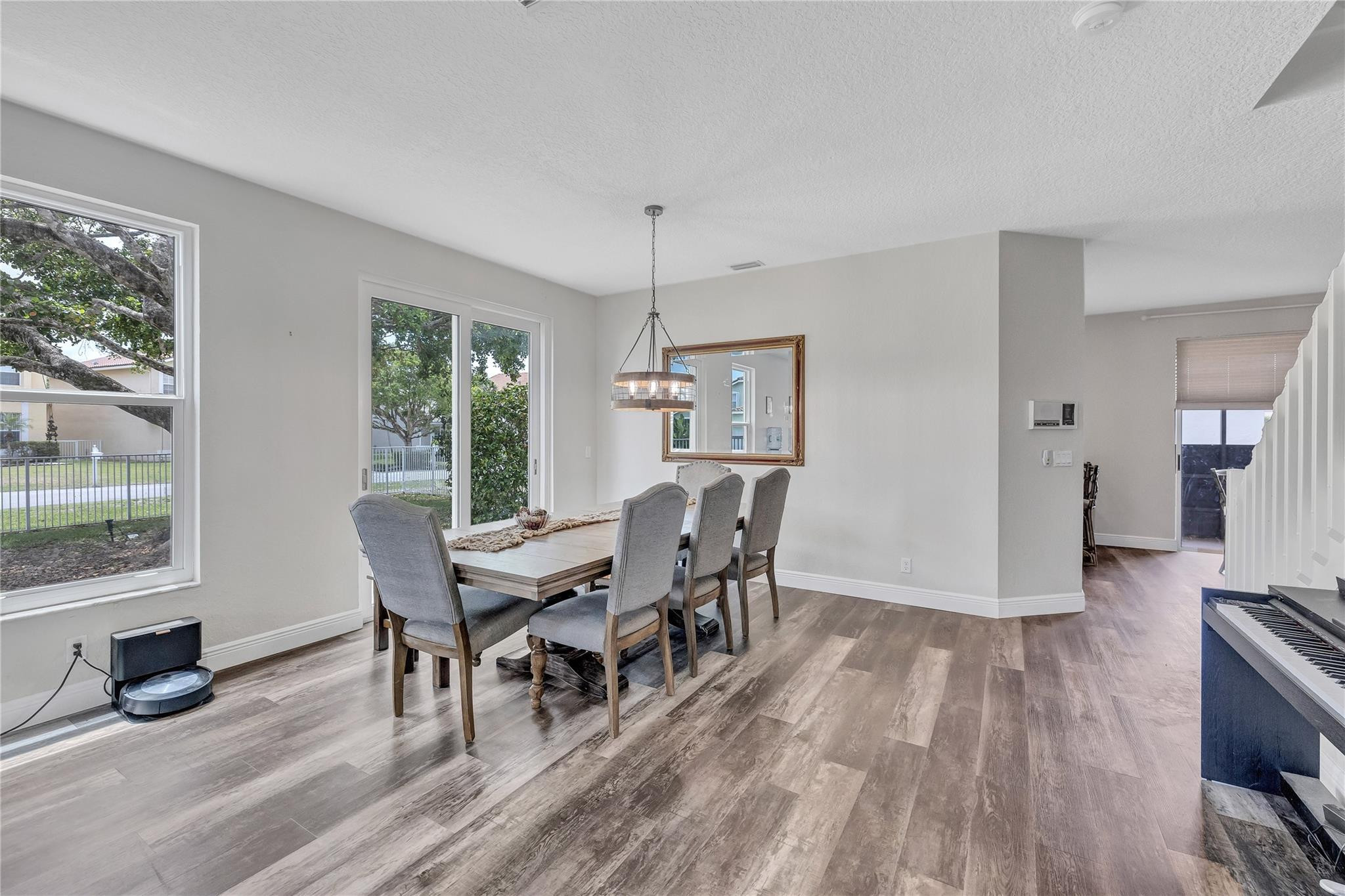 18219 Blue Lake Way Boca Raton, FL 33498 - Photo 5 of 39 a view of a dining room with furniture window and wooden floor