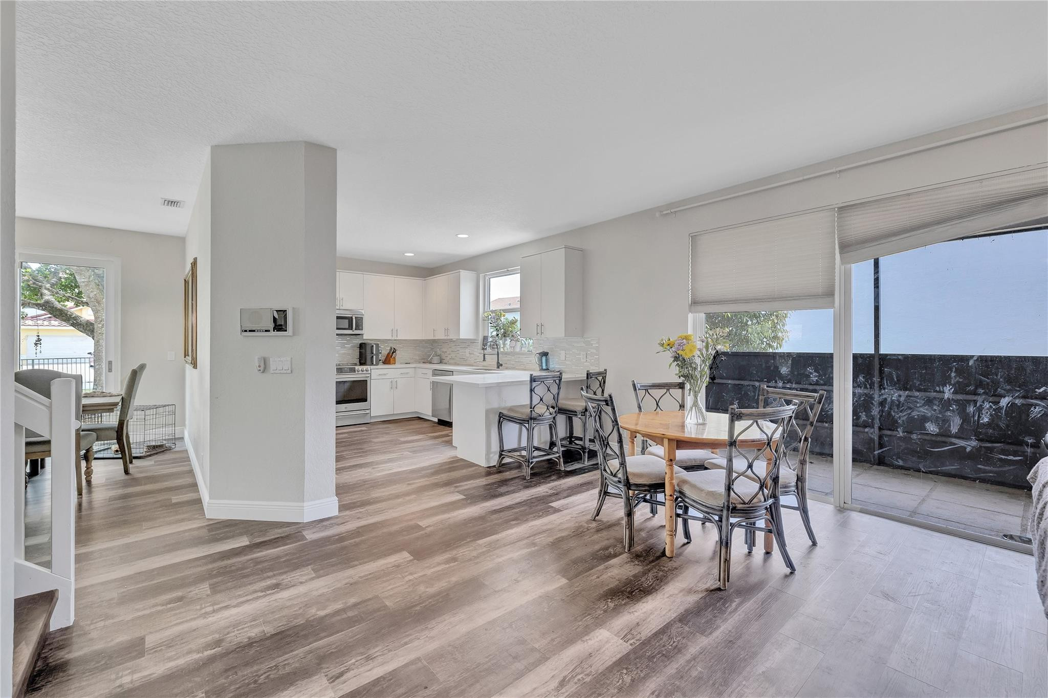 18219 Blue Lake Way Boca Raton, FL 33498 - Photo 9 of 39 a view of a dining room with furniture and wooden floor