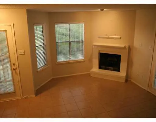 a kitchen with kitchen island granite countertop a sink cabinets and stainless steel appliances