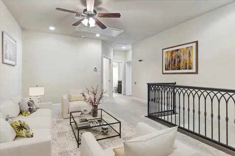 a living room with furniture and a chandelier
