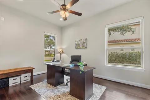 a view of a workspace with furniture and a window