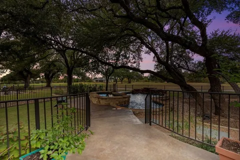 a view of a wrought iron fences in middle of house