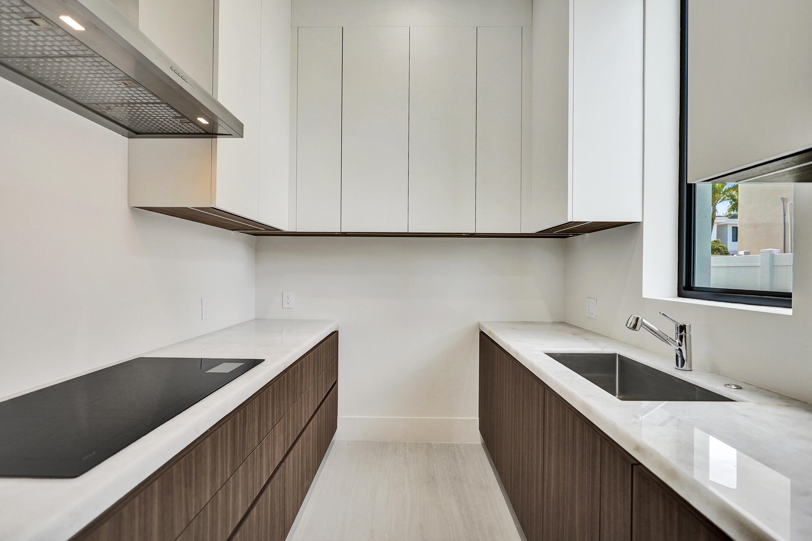 365 Northeast 3rd Street Boca Raton, FL 33432 - Photo 15 of 41 a kitchen with a sink and cabinets