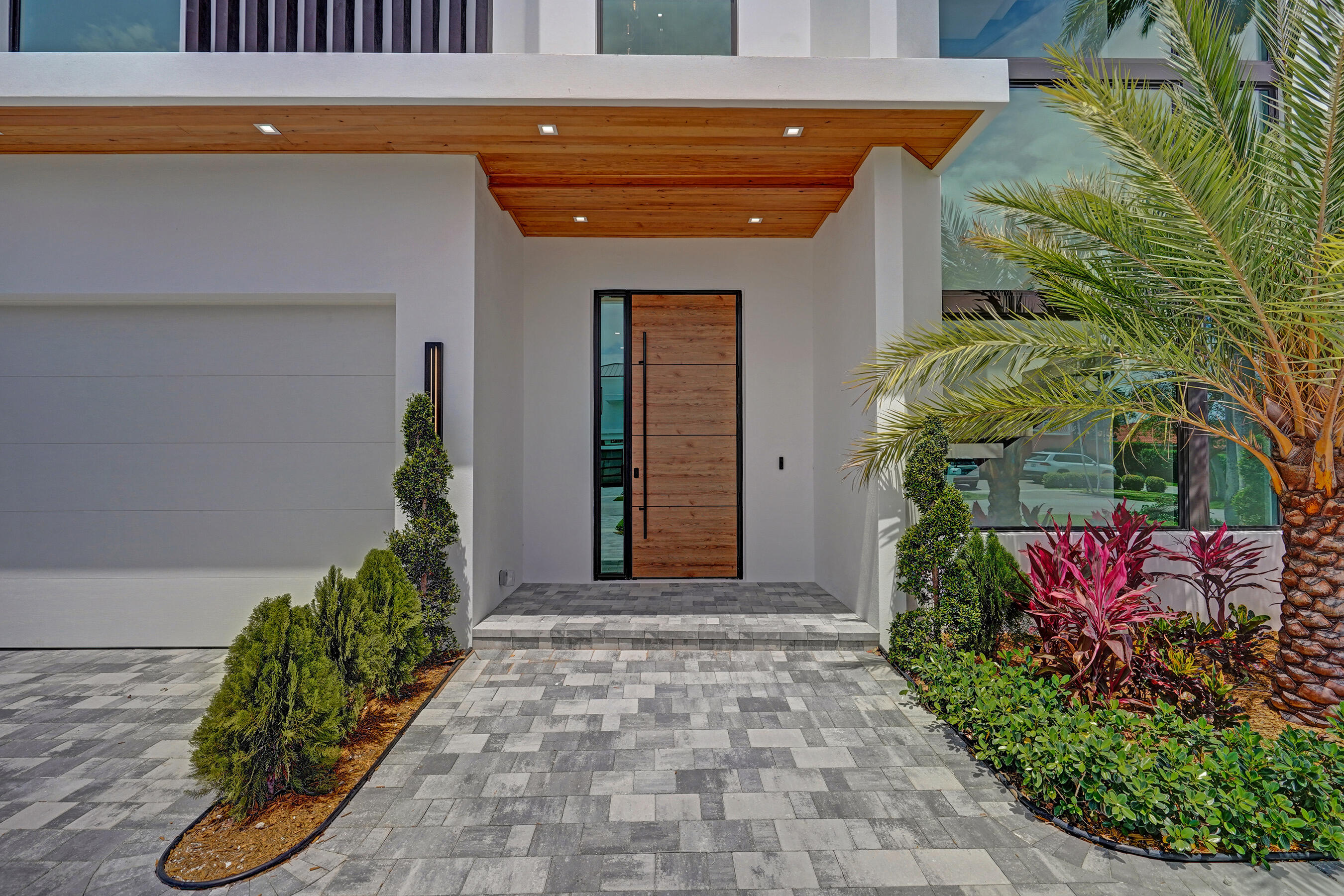365 Northeast 3rd Street Boca Raton, FL 33432 - Photo 2 of 41 a front view of a house with a yard
