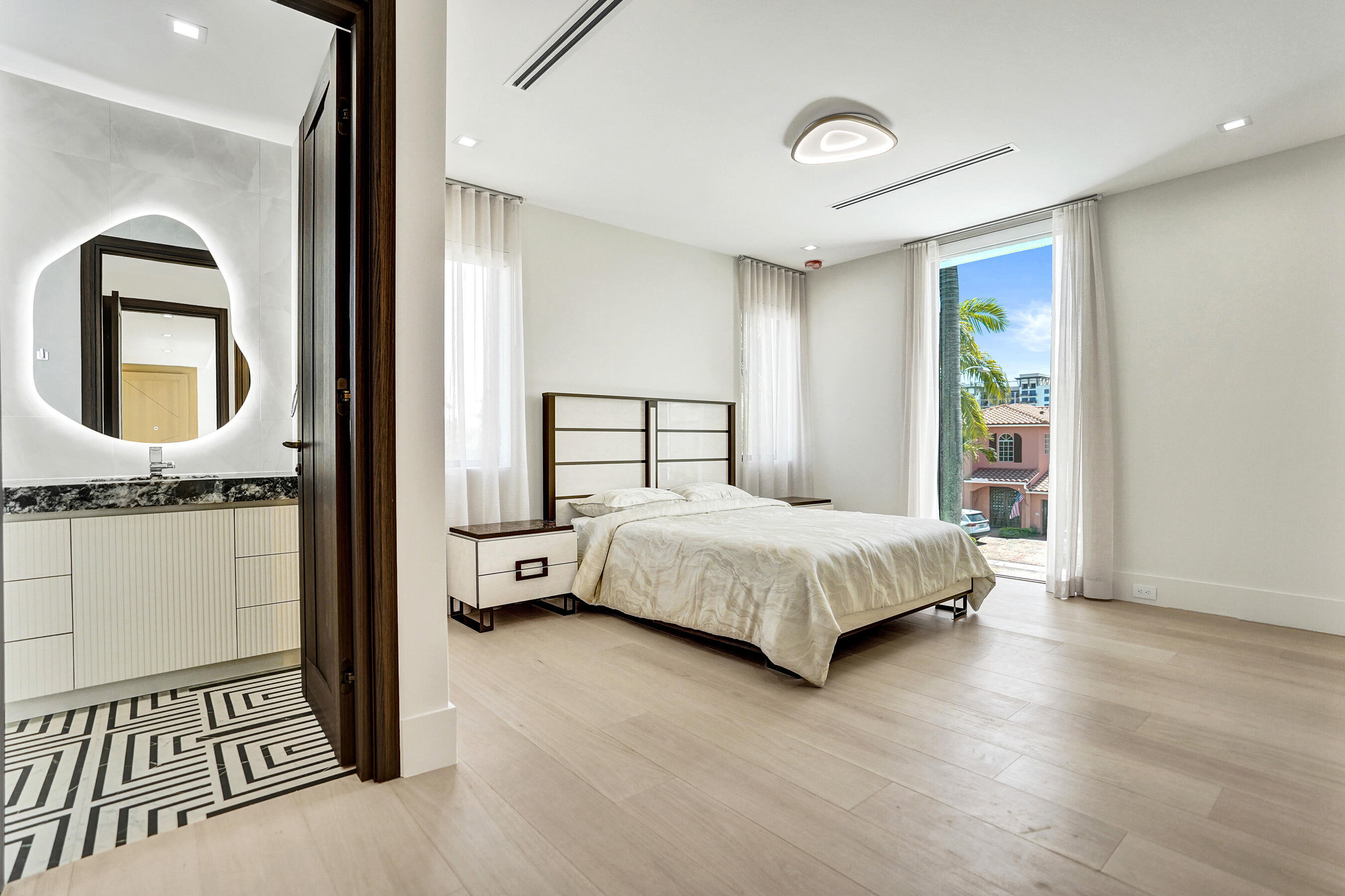 365 Northeast 3rd Street Boca Raton, FL 33432 - Photo 28 of 41 a bedroom with a bed and a mirror
