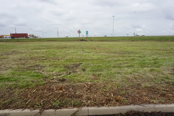 a view of a field with an ocean