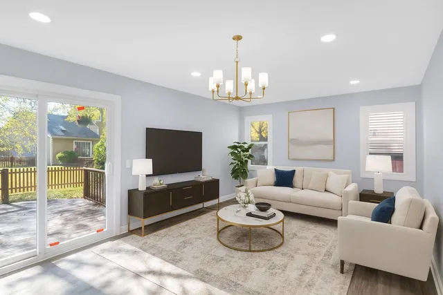 a living room with furniture a chandelier and a flat screen tv