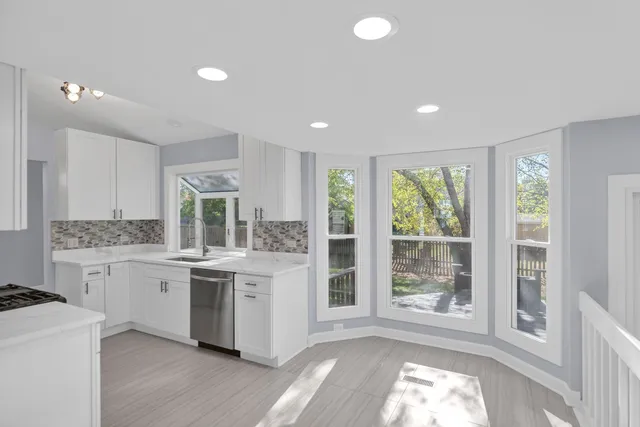 a kitchen with a stove a sink and a refrigerator