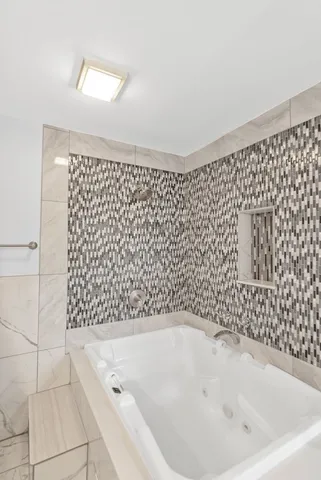 a bathroom with a bathtub and shower