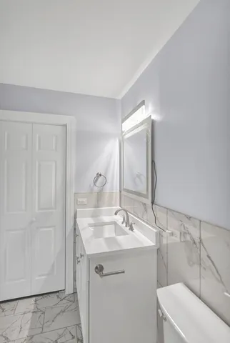 a bathroom with a sink toilet and vanity